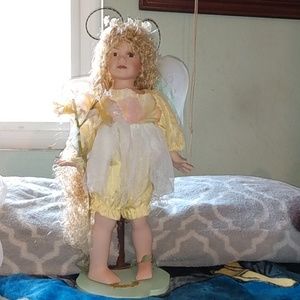 Porcelain Girl Doll with wings and stand.